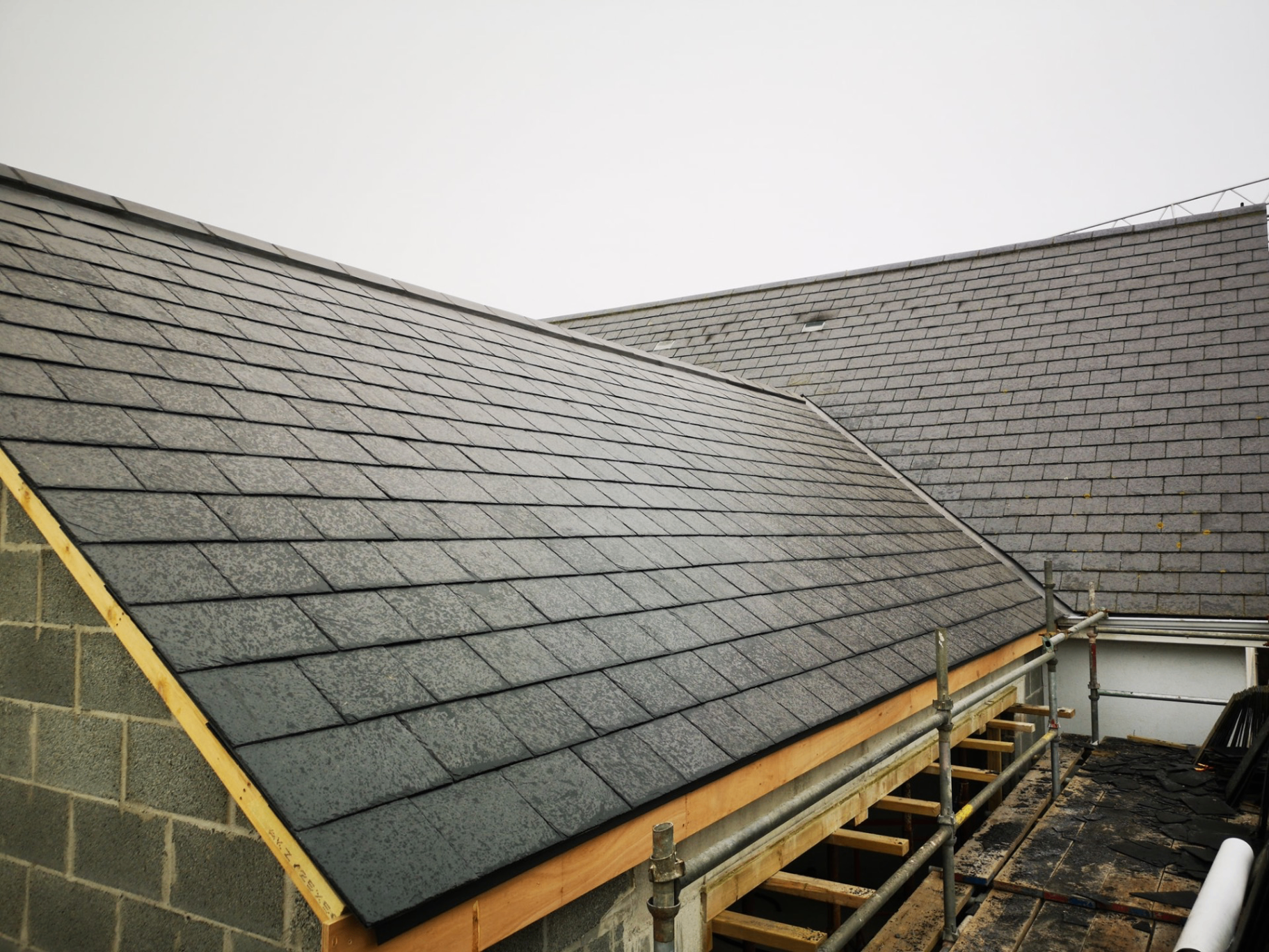 Restored natural slate roof on a Jersey granite cottage